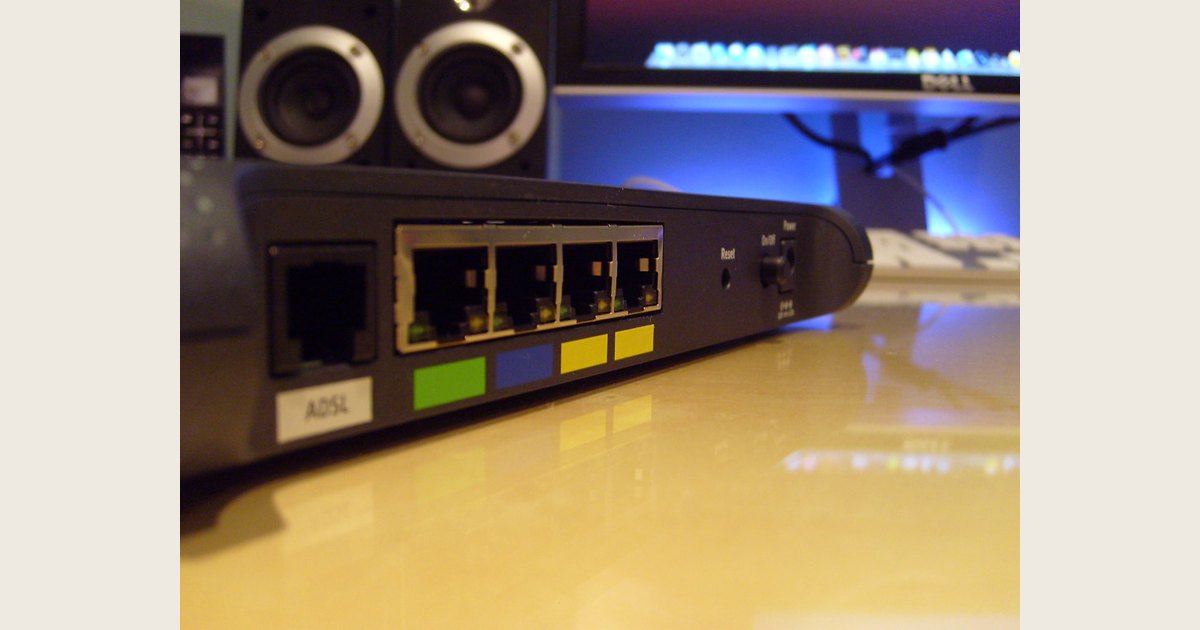 Router rear panel with Ethernet ports, a recessed Reset pinhole, and a separate Power On/Off control